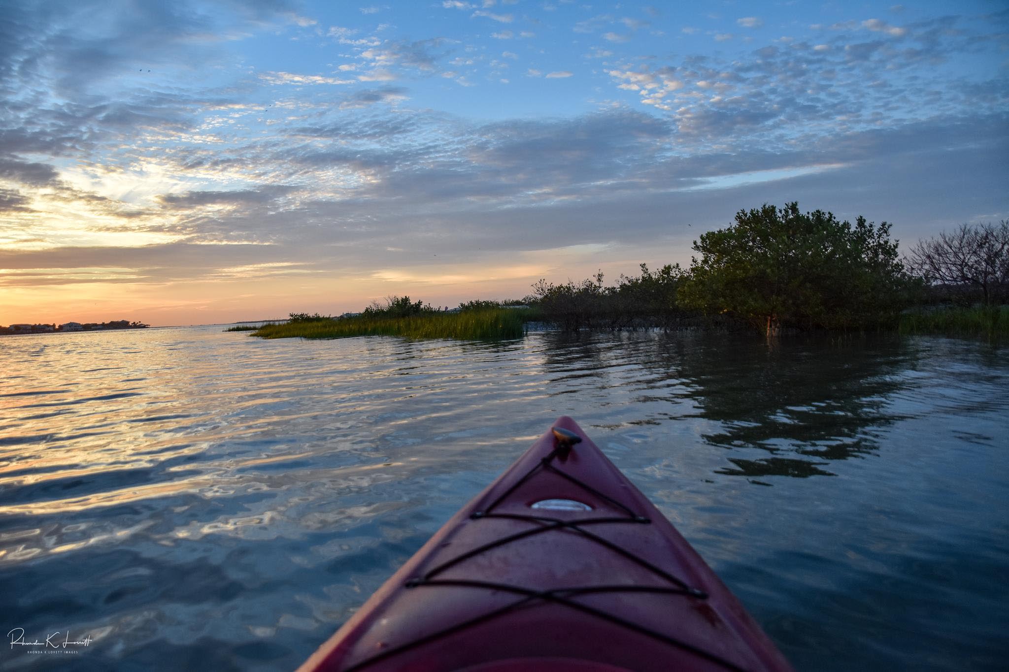 Kayak on calm water at sunset